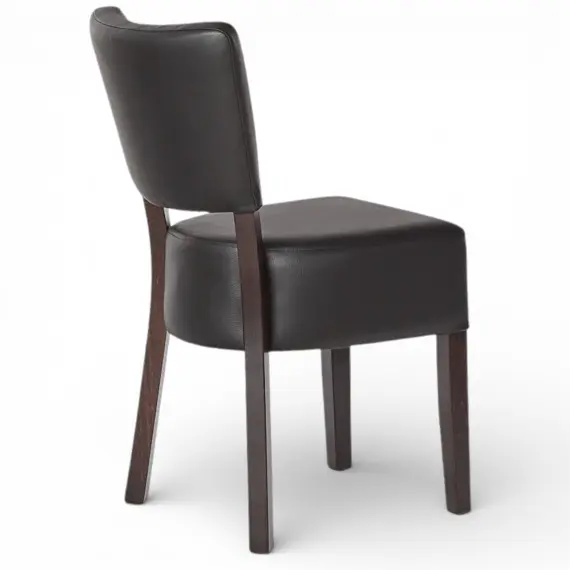 Oregon restaurant chair angled back view with curved upholstered backrest and solid wood frame